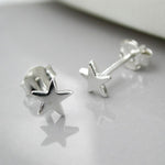 Tiny sterling silver star studs